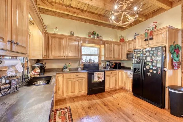 a kitchen with stainless steel appliances granite countertop a refrigerator and stove top oven