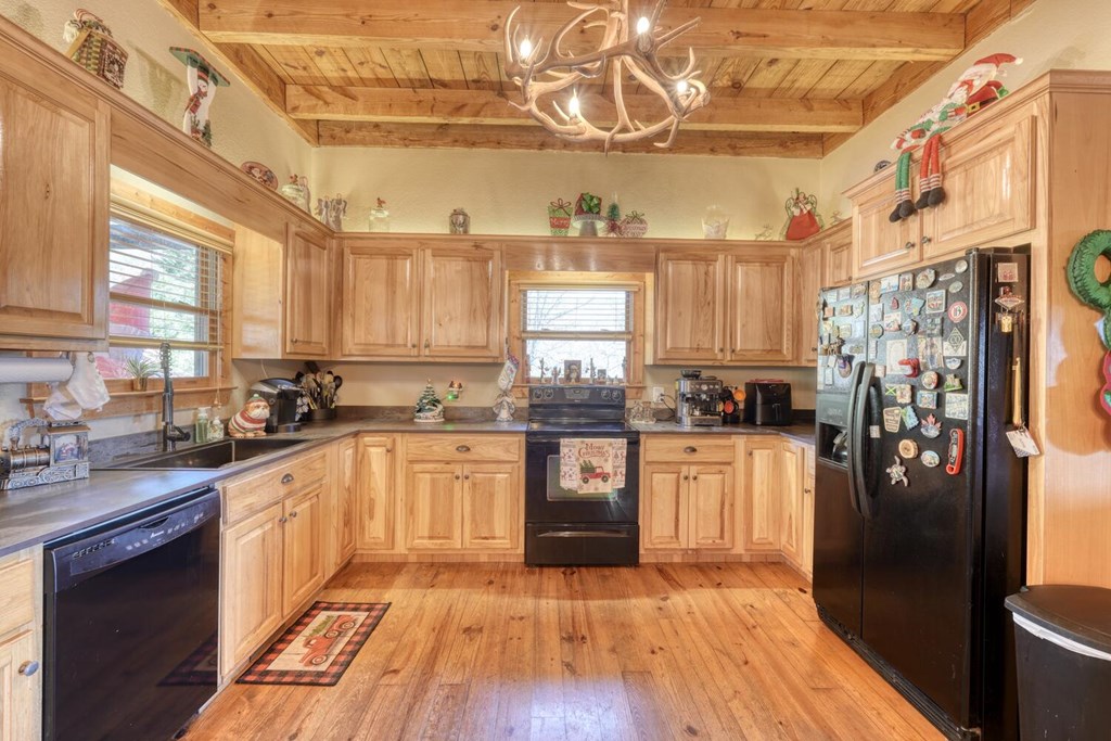 2567 Todd Shook Road Young Harris, GA 30582 - Photo 9 of 62 a kitchen with stainless steel appliances granite countertop a refrigerator a sink dishwasher a stove and white countertops with wooden floor