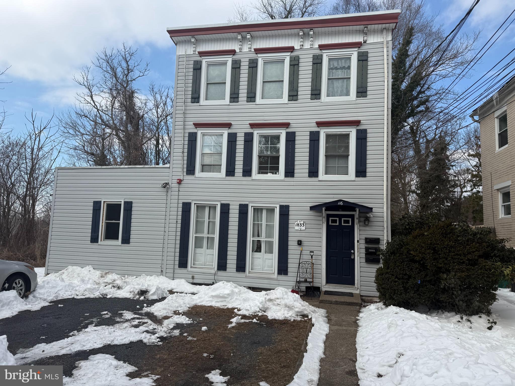 a view of a brick house with large windows