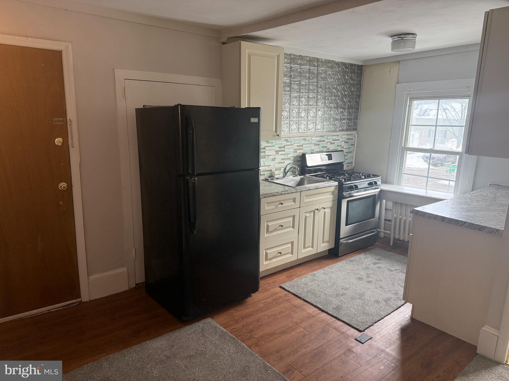 116 Walnut Street Bordentown, NJ 08505 - Photo 4 of 13 a kitchen with stainless steel appliances granite countertop a refrigerator stove and sink