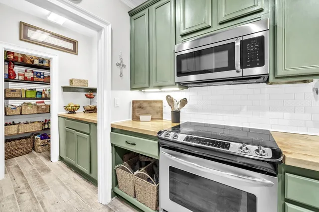 a kitchen with stainless steel appliances and cabinets
