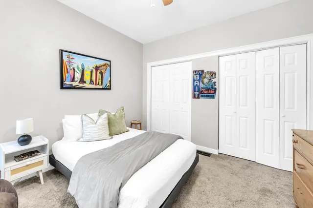 a bedroom with a bed and a chair