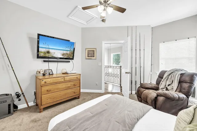 a living room with furniture and large windows