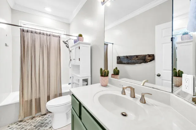 a living room with hardwood floor and large windows