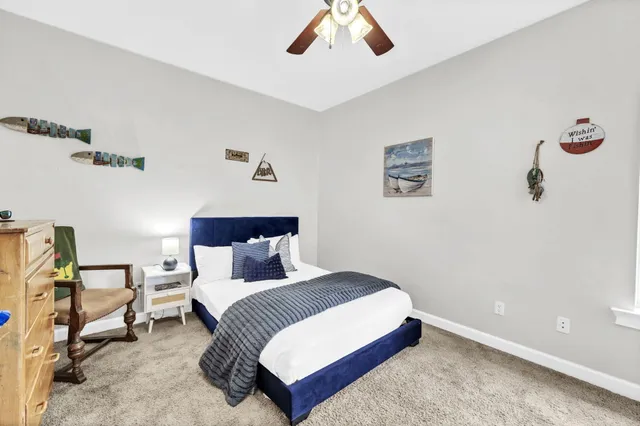 a bed sitting in a bedroom next to a large window