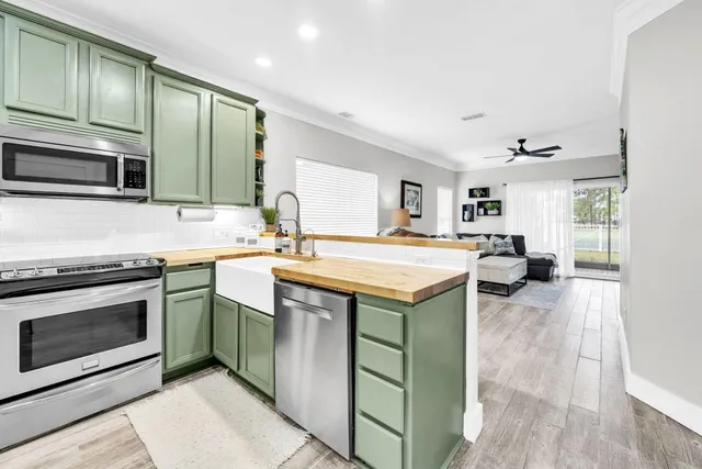 a kitchen with stainless steel appliances granite countertop a sink and stove top oven