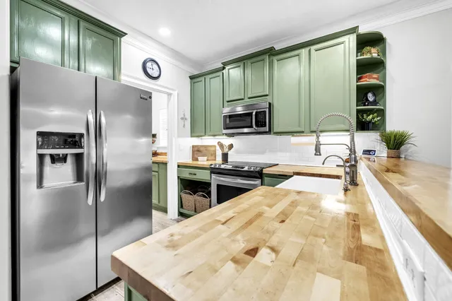 a kitchen with stainless steel appliances granite countertop a refrigerator and a sink