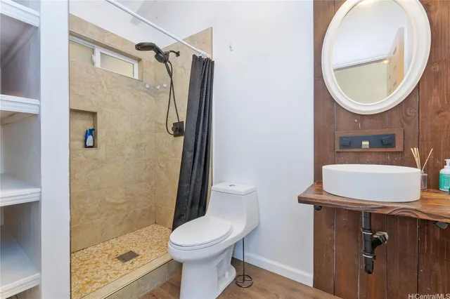a bathroom with a sink a toilet and a mirror