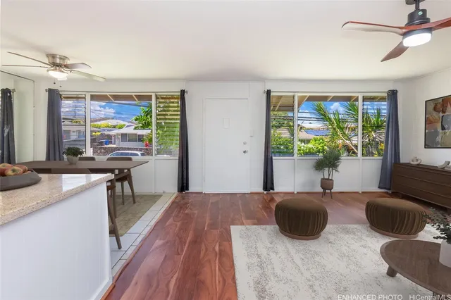 a living room with furniture and a floor to ceiling window
