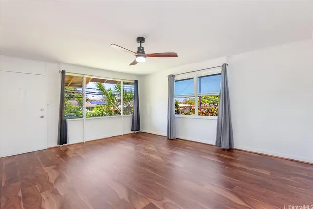 a view of room with window and wooden floor