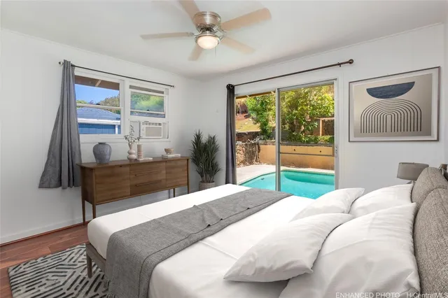 a bedroom with a bed and glass window