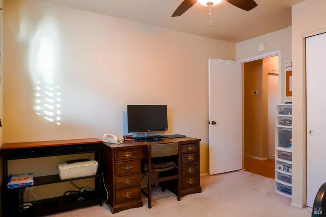 a view of workspace with furniture and closet