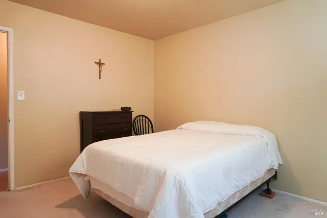 a bedroom with a bed and a night stand