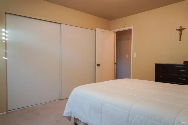 a bedroom with a bed and dresser