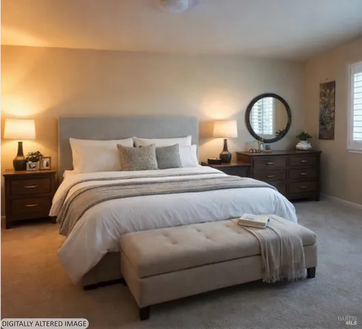 a bedroom with a bed lamps and a mirror