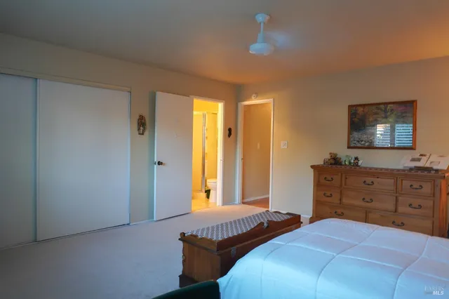 a bedroom with two beds and a dresser