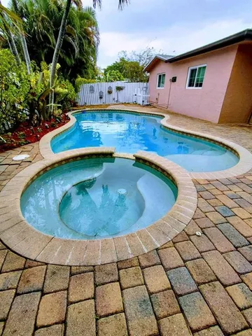 a view of a swimming pool with an outdoor seating