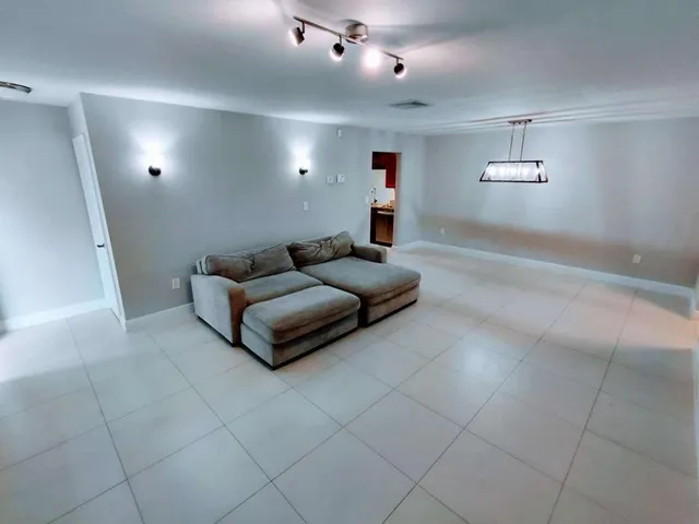 a living room with furniture and a projector screen