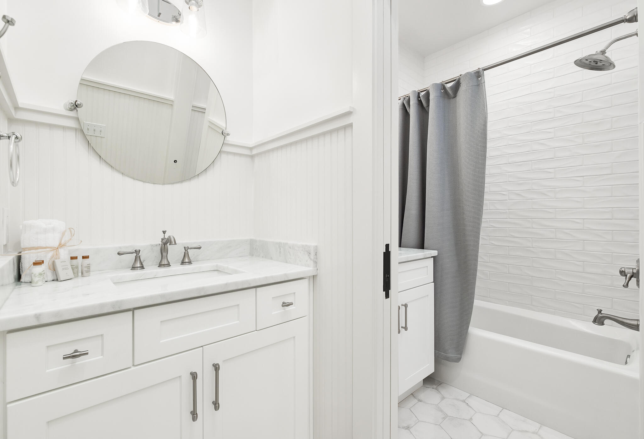 290 Salt Watersound, FL 32461 - Photo 21 of 45 a bathroom with a granite countertop sink vanity mirror bathtub shower and a mirror