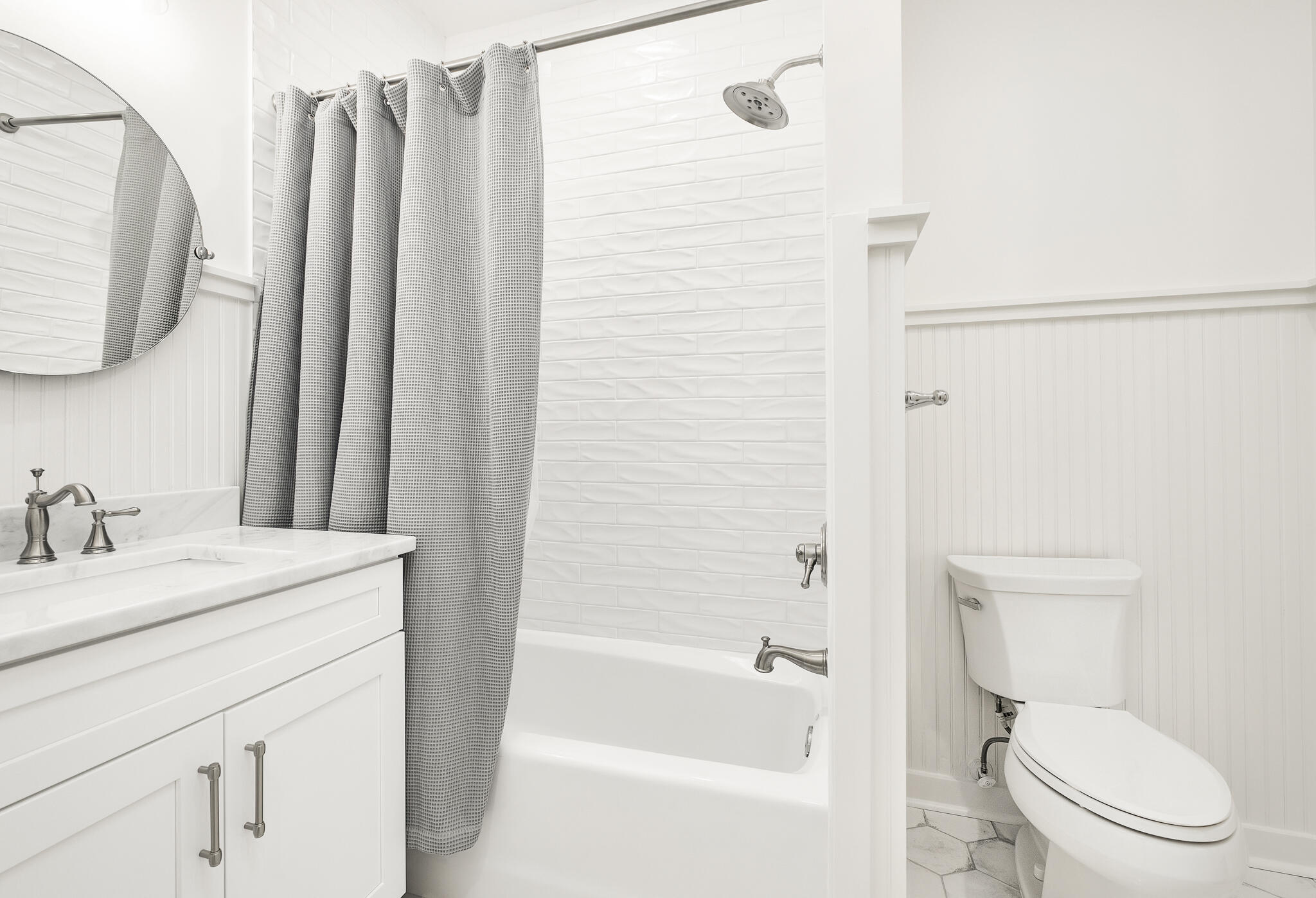 290 Salt Watersound, FL 32461 - Photo 22 of 45 a bathroom with a granite countertop toilet sink and a mirror