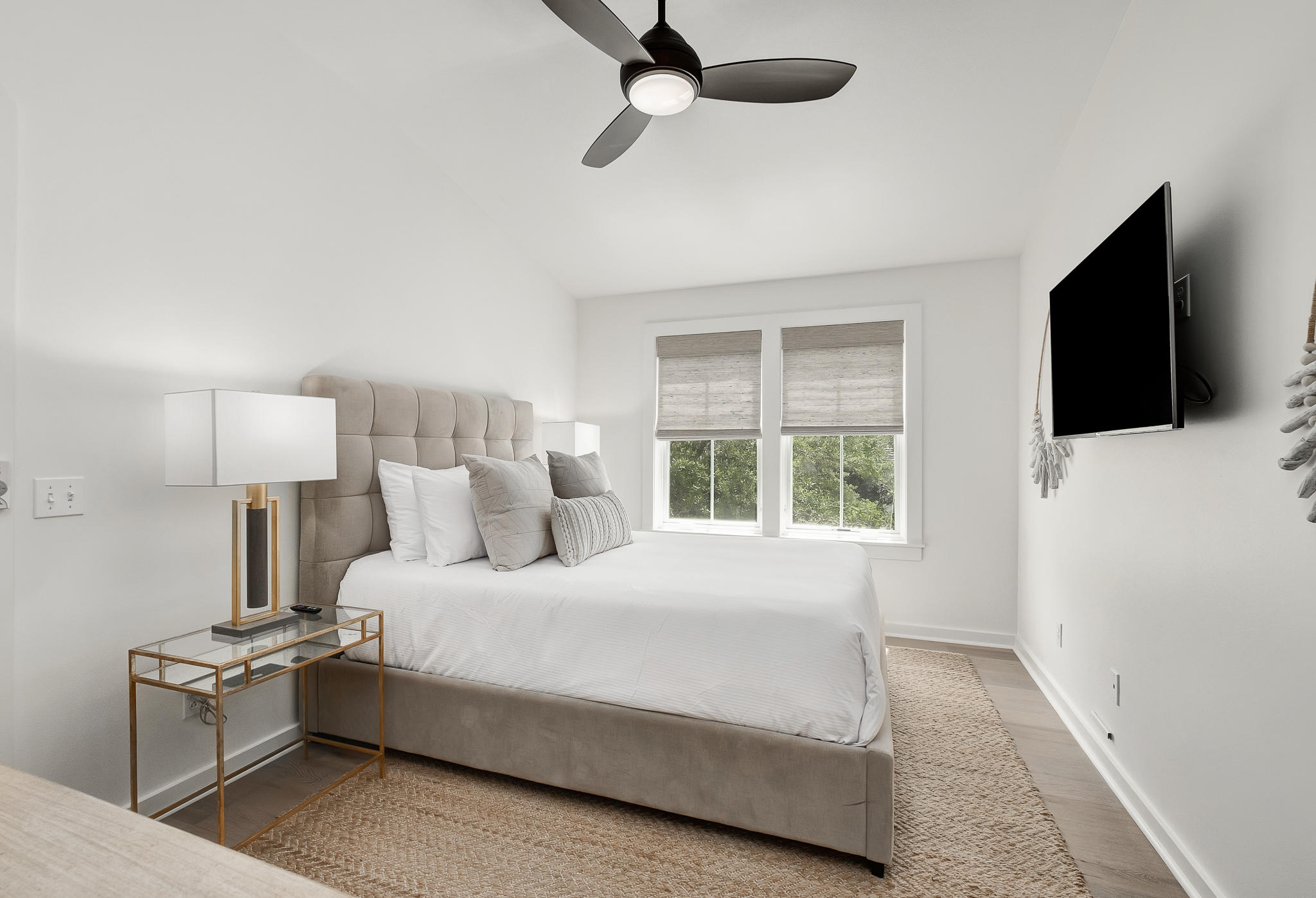 290 Salt Watersound, FL 32461 - Photo 26 of 45 a bedroom with a bed tv and a window