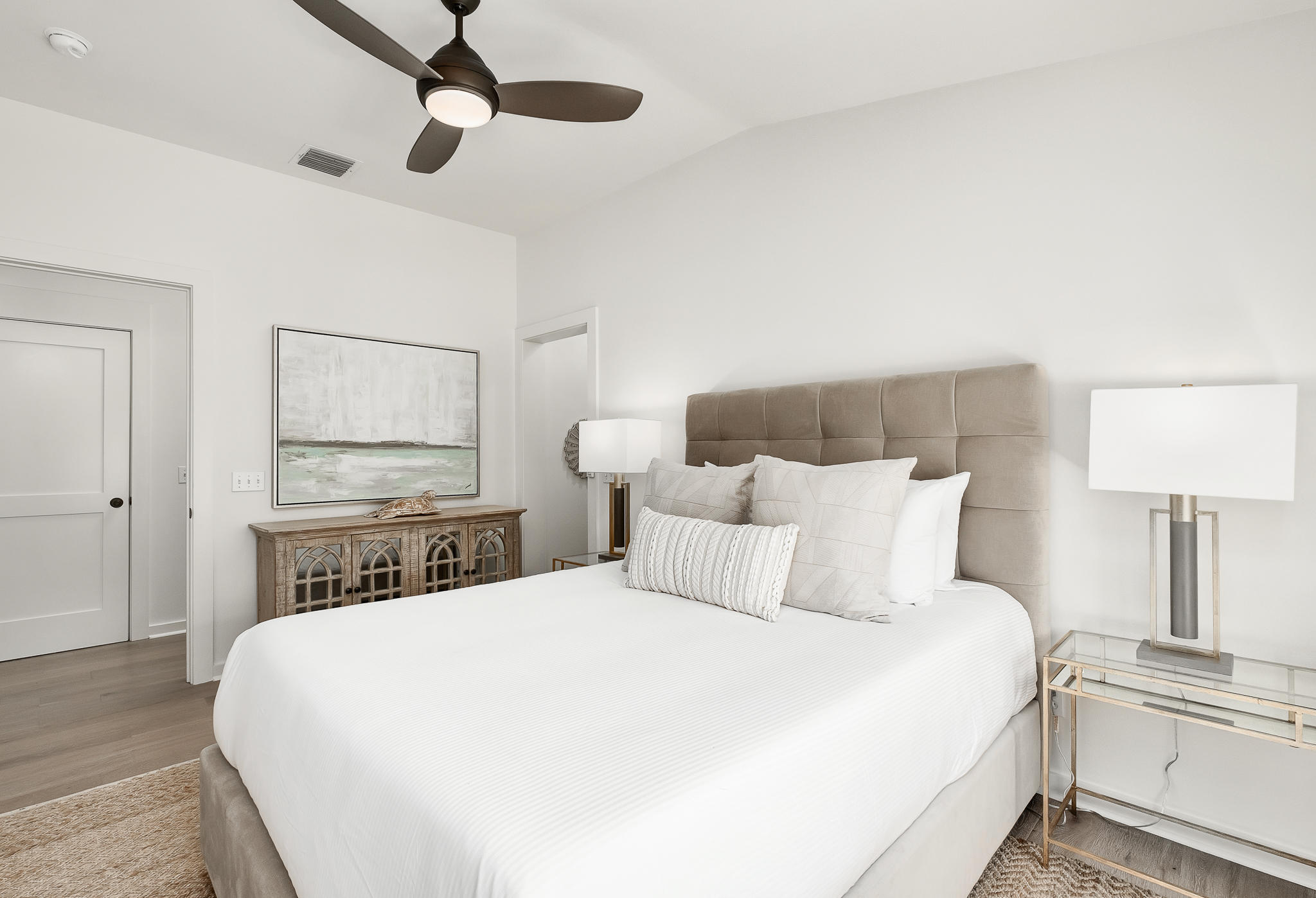 290 Salt Watersound, FL 32461 - Photo 27 of 45 a bedroom with a bed and a lamp