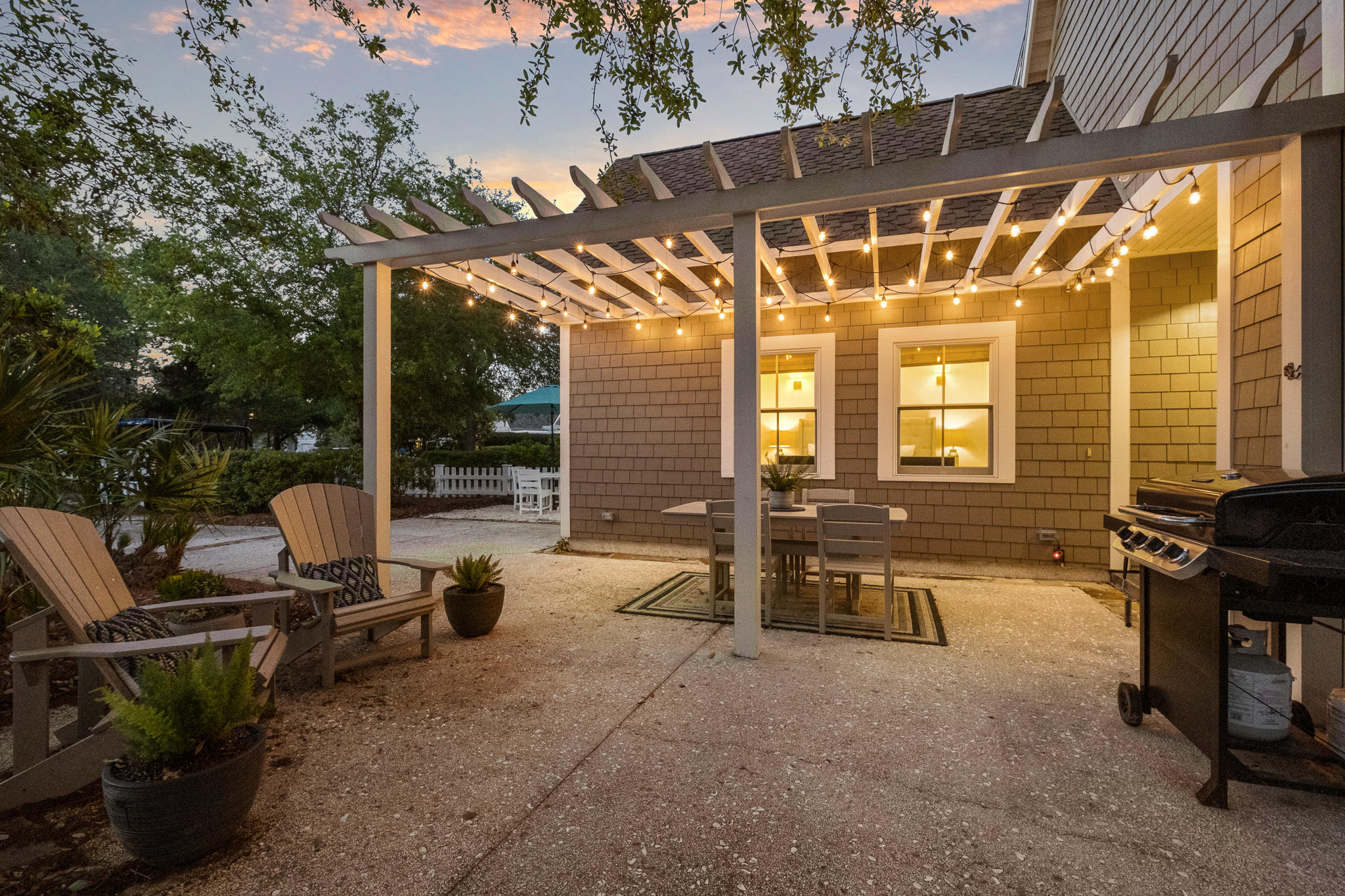 290 Salt Watersound, FL 32461 - Photo 40 of 45 a view of a patio with table and chairs and potted plants