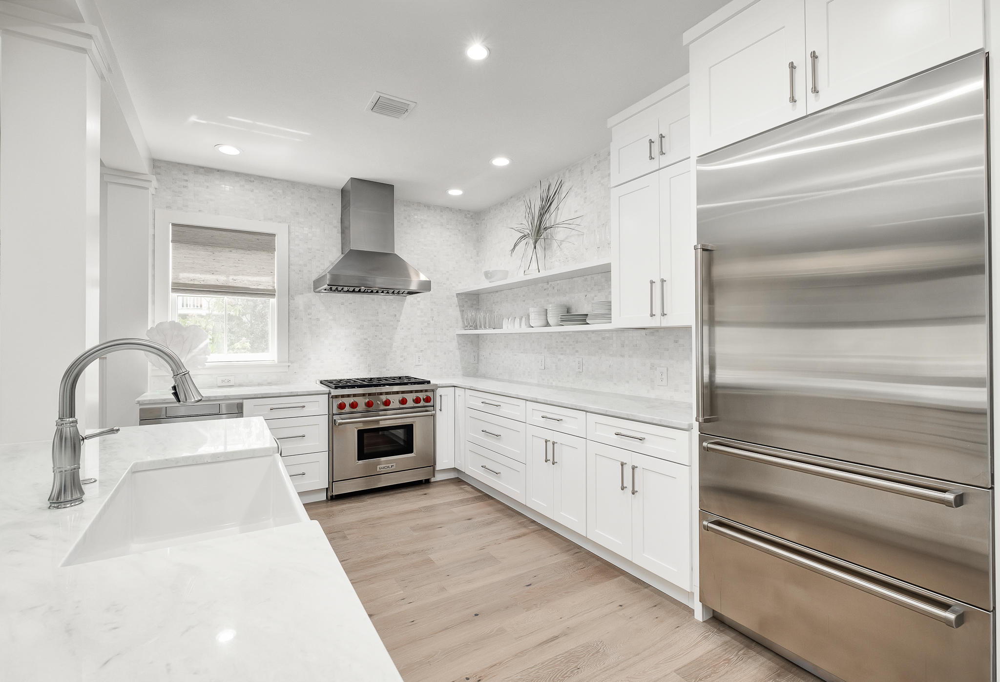 290 Salt Watersound, FL 32461 - Photo 6 of 45 a kitchen with granite countertop stainless steel appliances and white cabinets