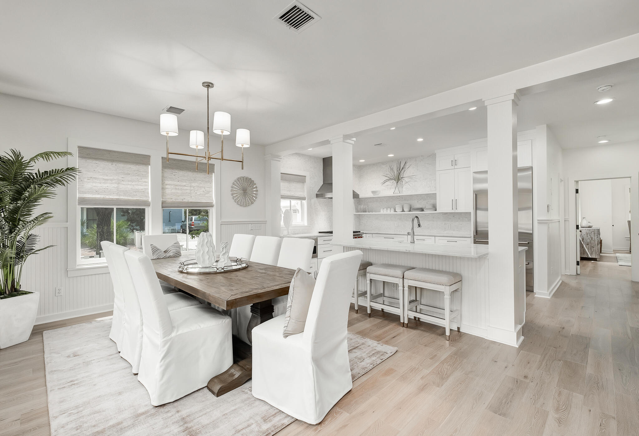 290 Salt Watersound, FL 32461 - Photo 9 of 45 a view of a dining room with furniture wooden floor and chandelier
