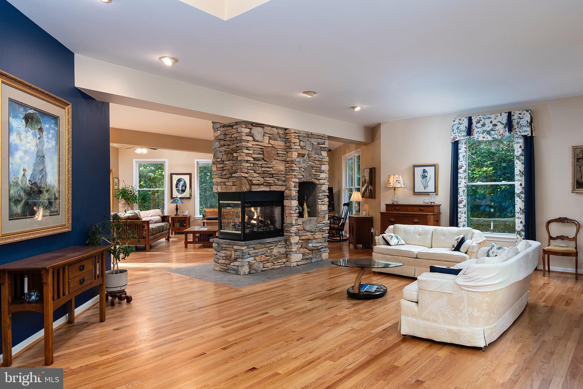 2420 SW Road Baltimore, MD 21234 - Photo 7 of 46 Open living spaces with stacked stone fireplace