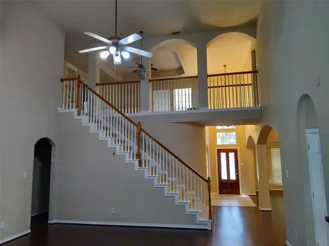 a view of staircase with railing and wooden floor