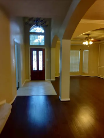a view of a hallway with wooden floor