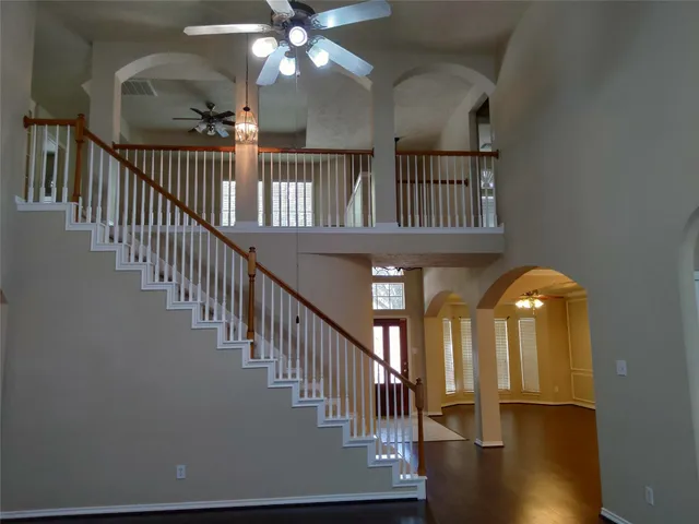 a view of staircase with railing and wooden floor