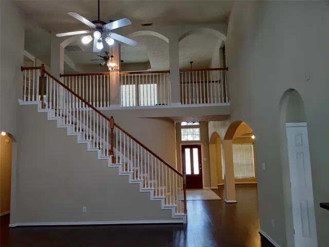 a view of staircase with railing and wooden floor