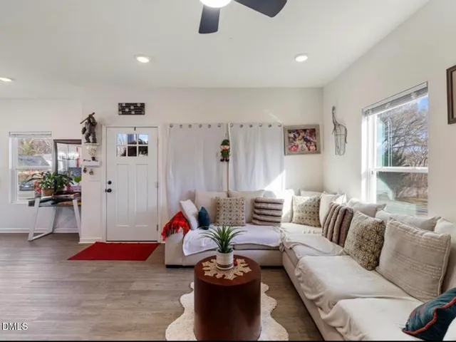 a living room with furniture or couch and a potted plant
