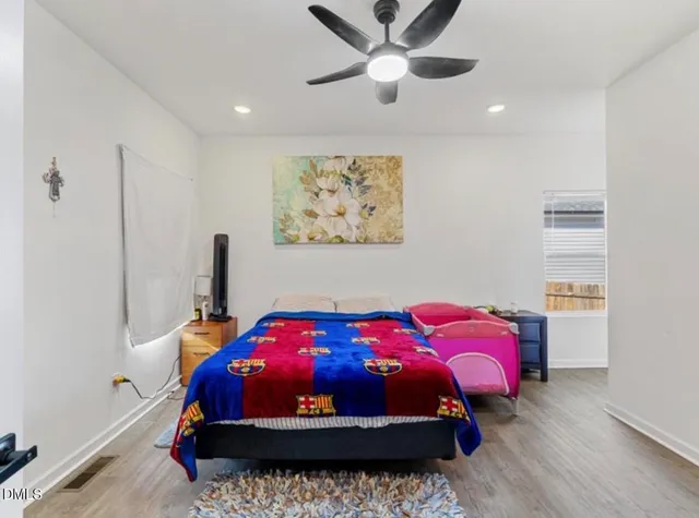 a bed room with a bed and a chandelier