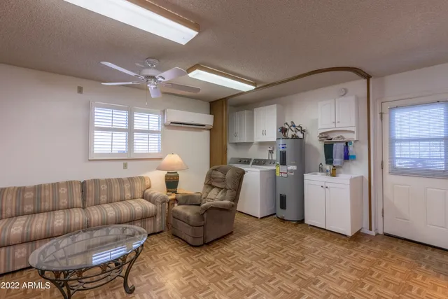 a living room with furniture and kitchen view