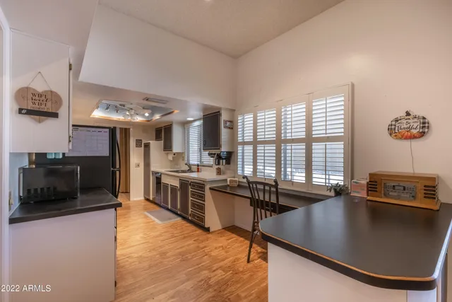 a kitchen with stainless steel appliances granite countertop a sink a stove and a refrigerator