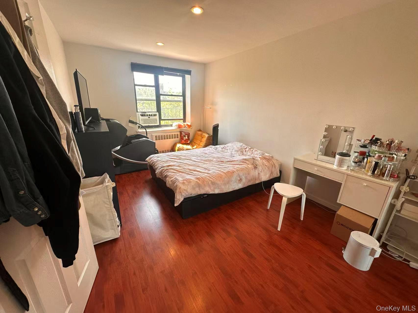 139-15 28th Road, Unit 6G Queens, NY 11354 - Photo 18 of 20 a bedroom with furniture and a window