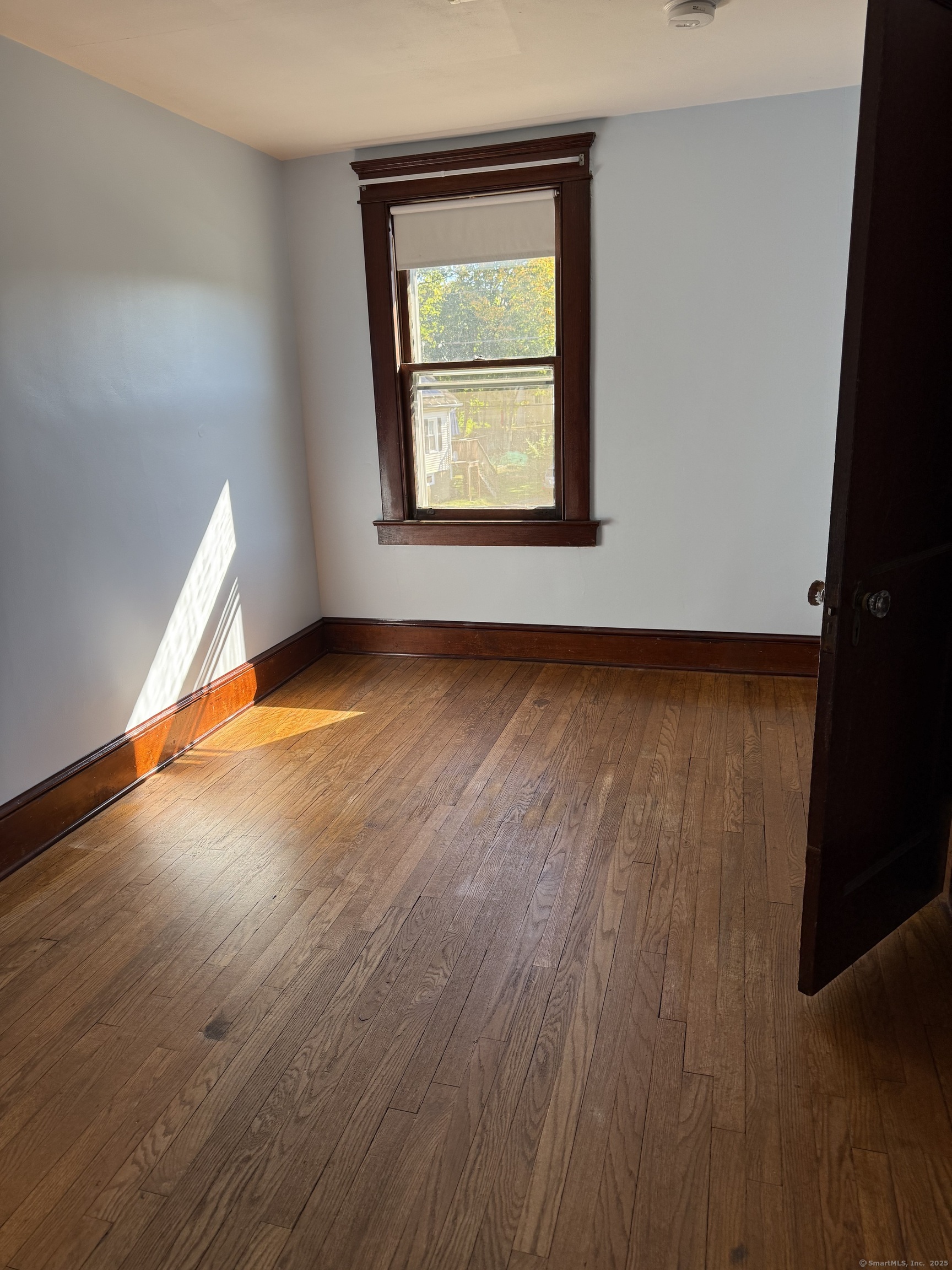 28 Galpin Street Naugatuck, CT 06770 - Photo 14 of 18 a view of an empty room with wooden floor and a window