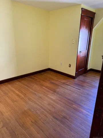 a view of an empty room and wooden floor