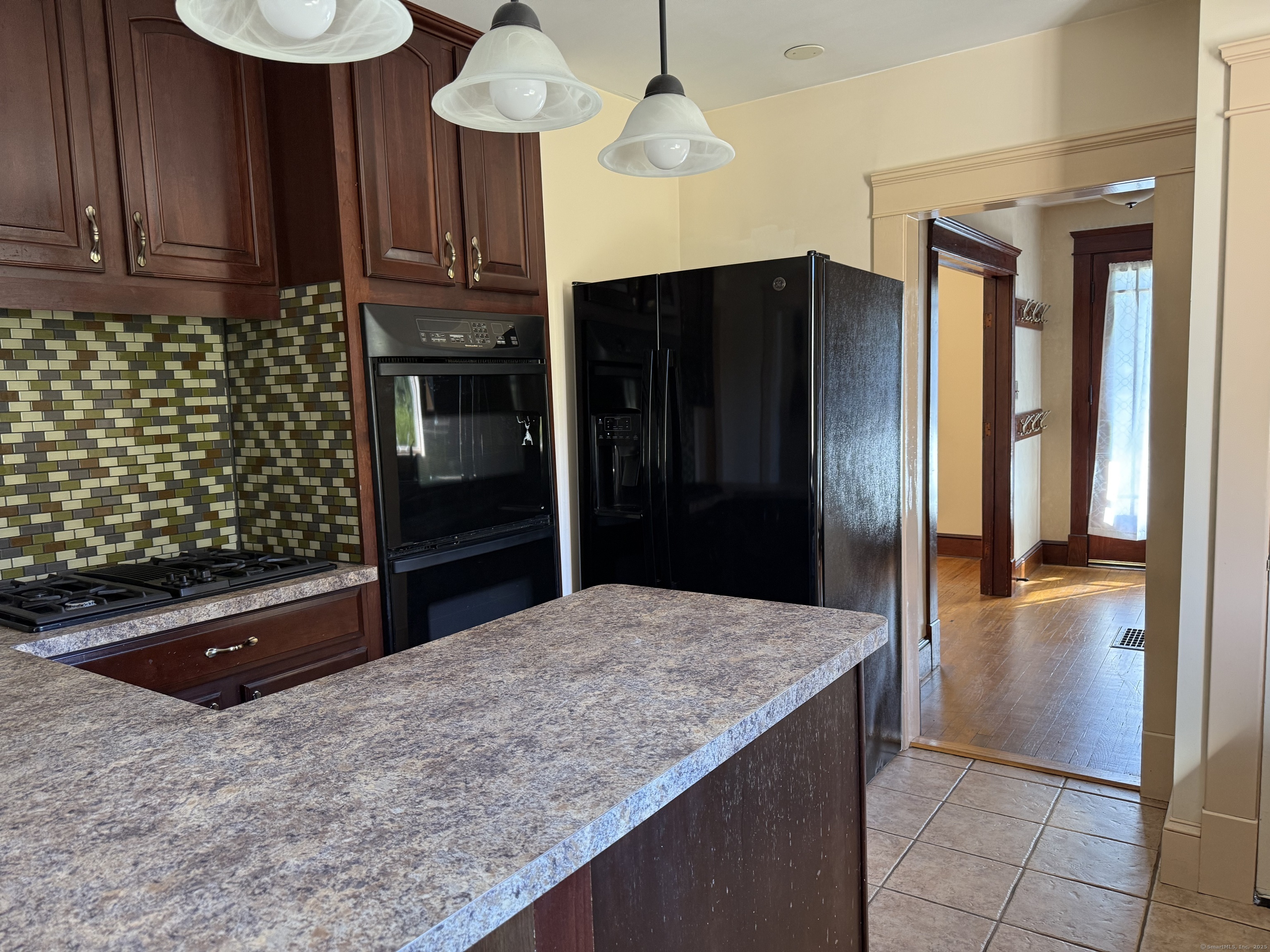 28 Galpin Street Naugatuck, CT 06770 - Photo 4 of 18 a kitchen with kitchen island a counter top space a sink stainless steel appliances and cabinets