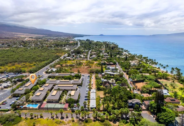 an aerial view of residential building and lake