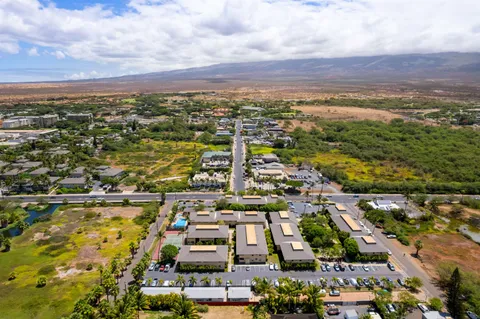 an aerial view of residential building and car parked