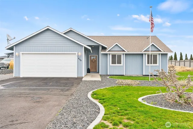 a view of a house with a yard and garage