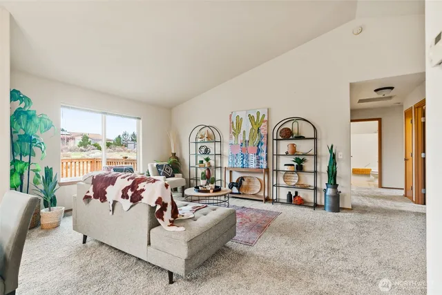 a living room with fireplace furniture and a large window