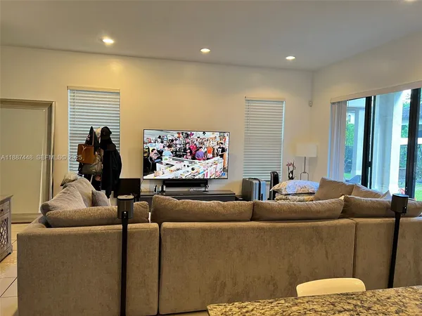 a living room with furniture and a flat screen tv