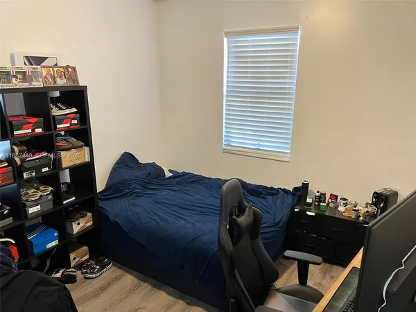 a bed sitting in a bedroom next to a window