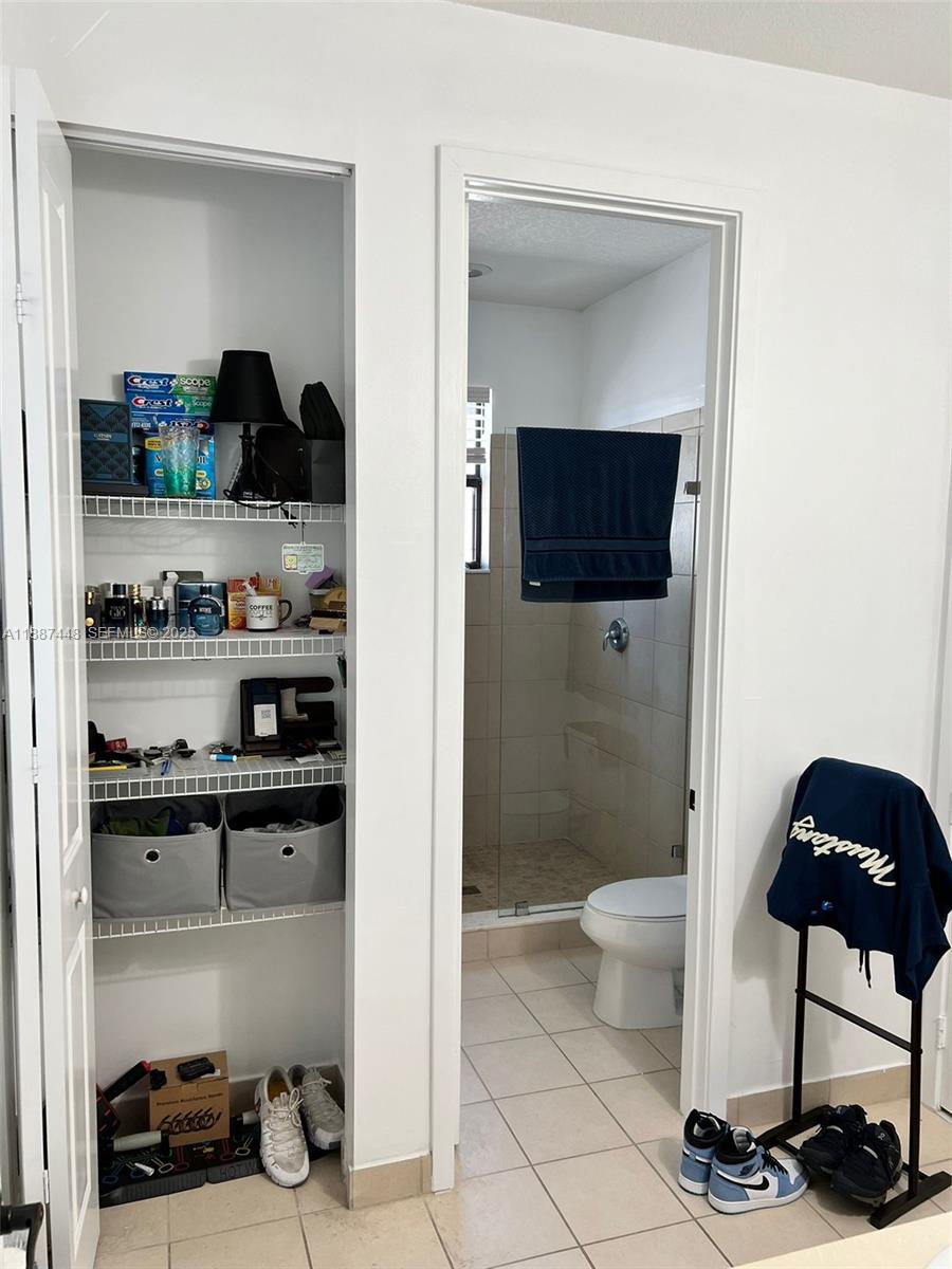 3214 West 97th Street Hialeah, FL 33018 - Photo 21 of 22 a bathroom with a toilet and a shower