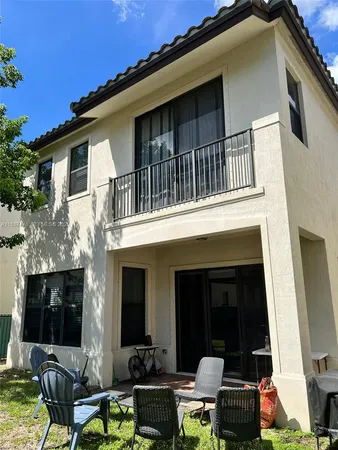 a view of a house with a chairs in patio